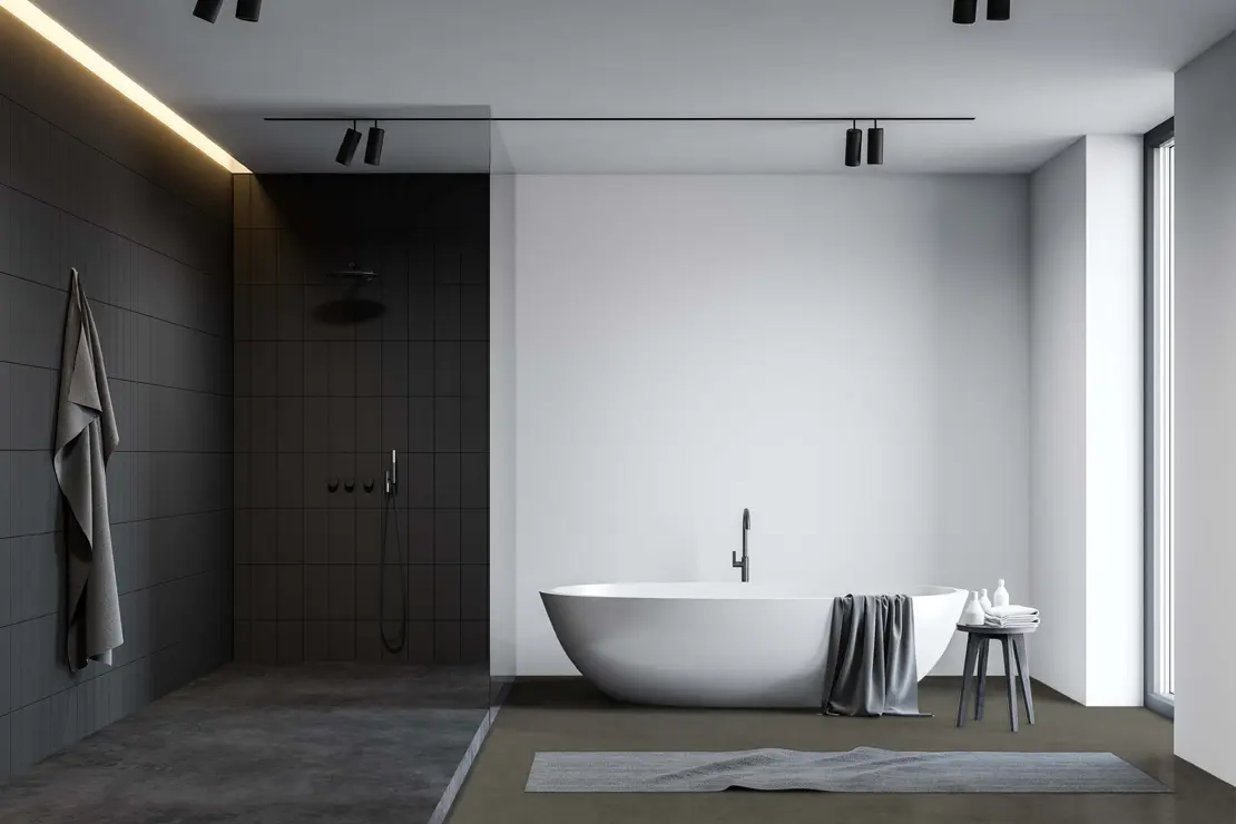 Bañera con pavimento de microcemento de tonalidad gris profundo. Bañera con pavimento de microcemento de tonalidad gris profundo.